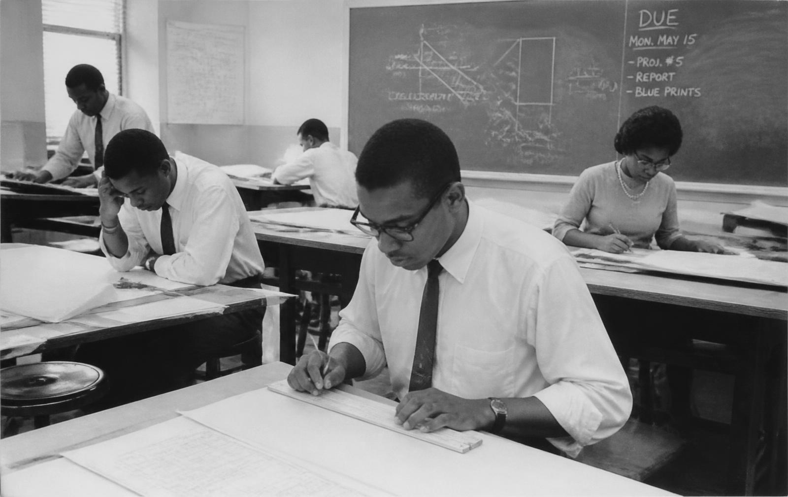 Archival photograph of engineering students at drafting tables